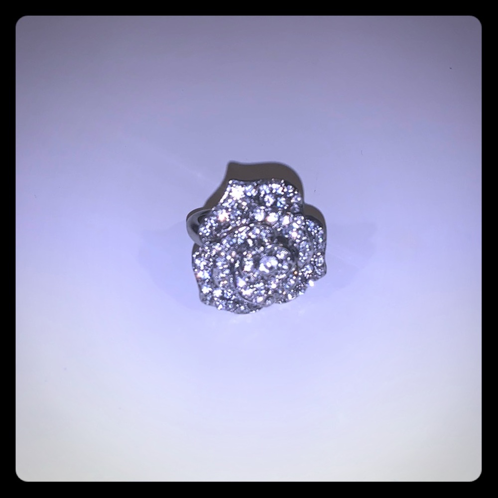 Silver gem studded rose statement ring.